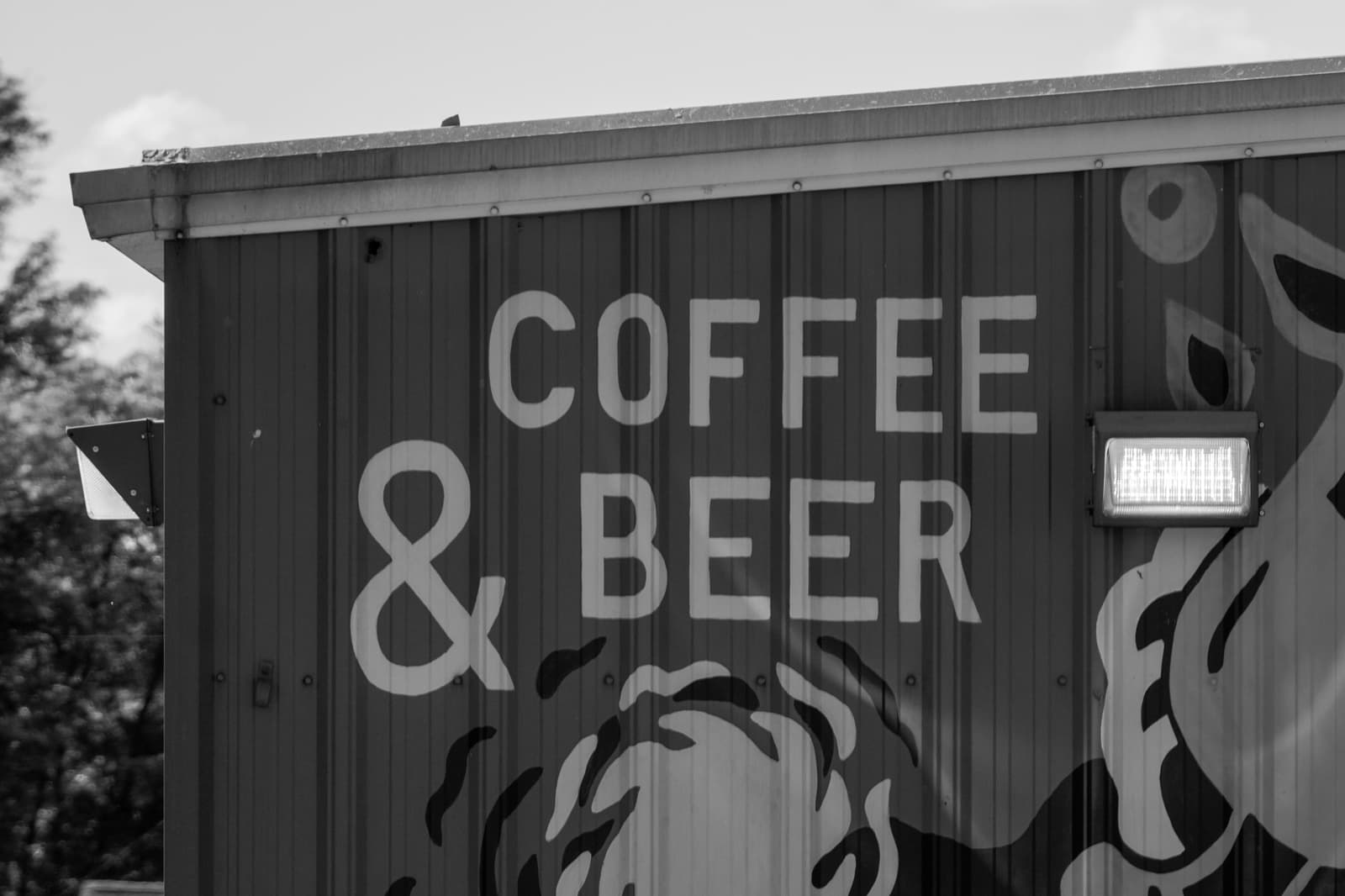 A painted Coffee & Beer sign on a building in East Nashville